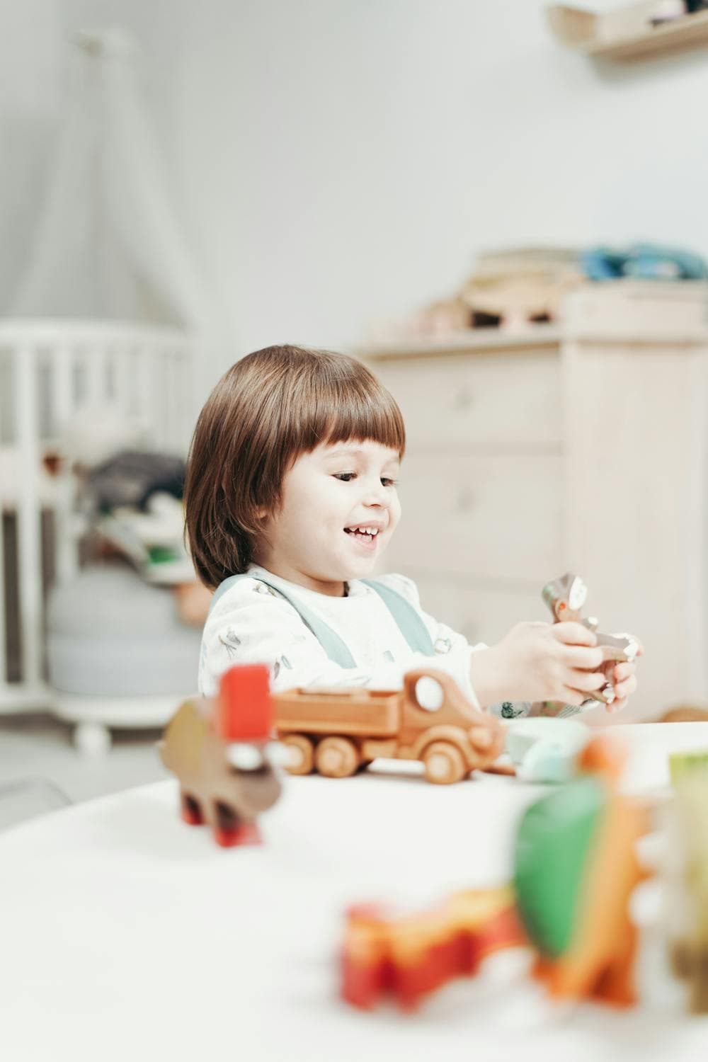 A happy toddler playing with colorful building blocks indoors